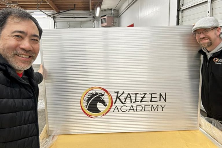 Coaches Pose With New Materials For Kaizen Academy Riverside