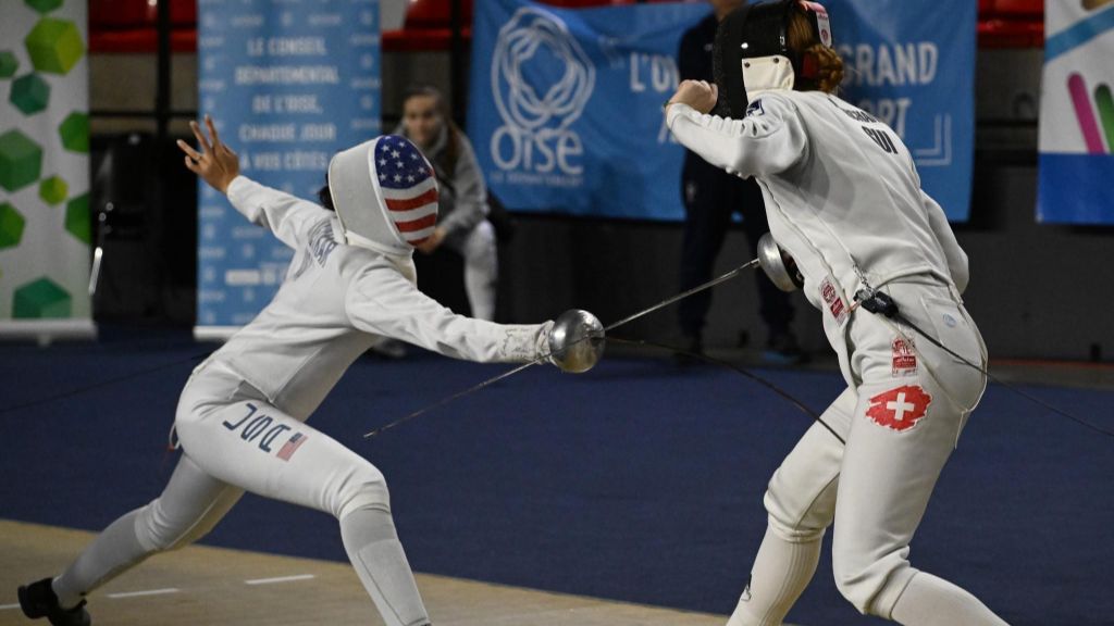 Two people practicing a fencing dual