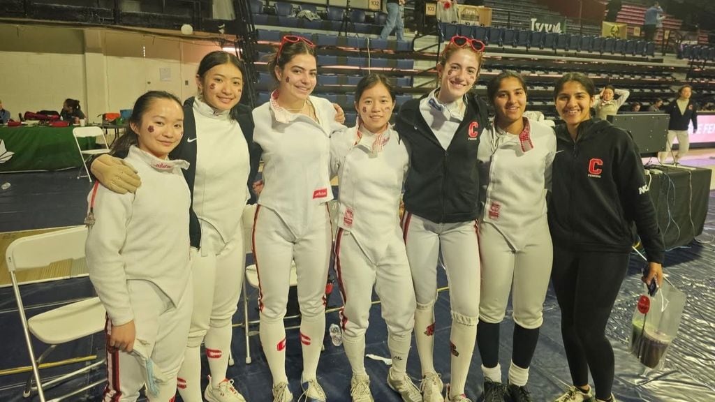 Fencing team standing with their coach representing Kaizen Acaedmy's fencing camp curriculum to help their students learn and evolve as athletes.