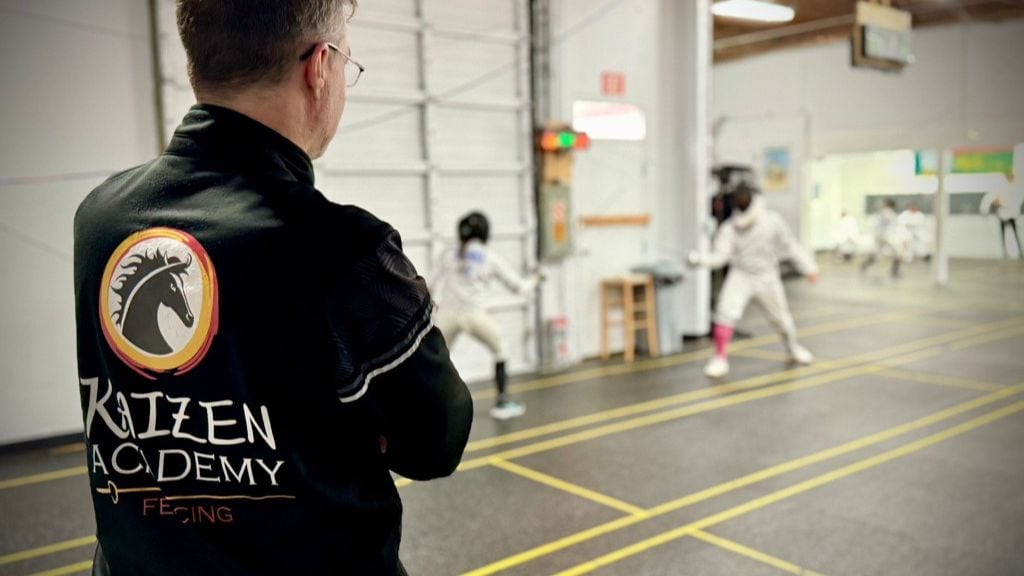 Instructor from Kaizen Academy giving fencing lessons
