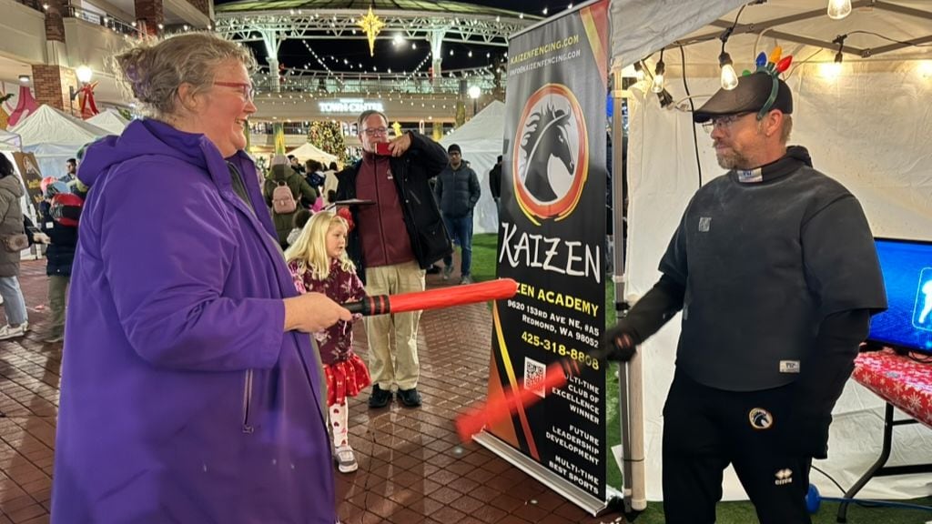 Two adults preparing to fence.